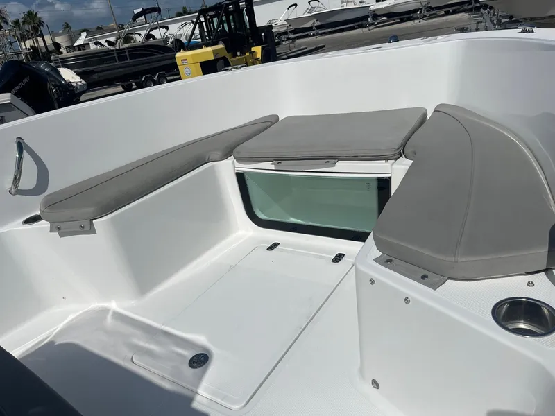 Slide: The Image of 2022 Wellcraft 202 Fisherman boat interior with cushioned seating and storage. - 7