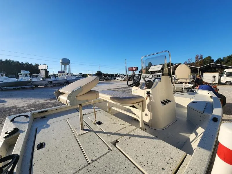Slide: The Image of 2015 Xpress Hyper-Lift Bay Series H18B boat in a marina under clear blue sky. - 15