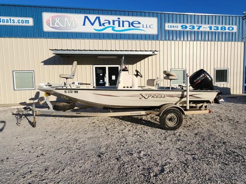 Slide: The Image of 2015 Xpress Hyper-Lift Bay Series H18B boat on trailer outside marine dealership. - 2