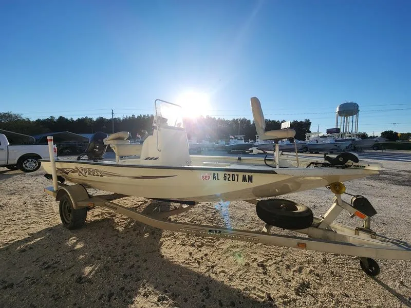 Slide: The Image of 2015 Xpress Hyper-Lift Bay Series H18B boat on trailer, sunlit background. - 5