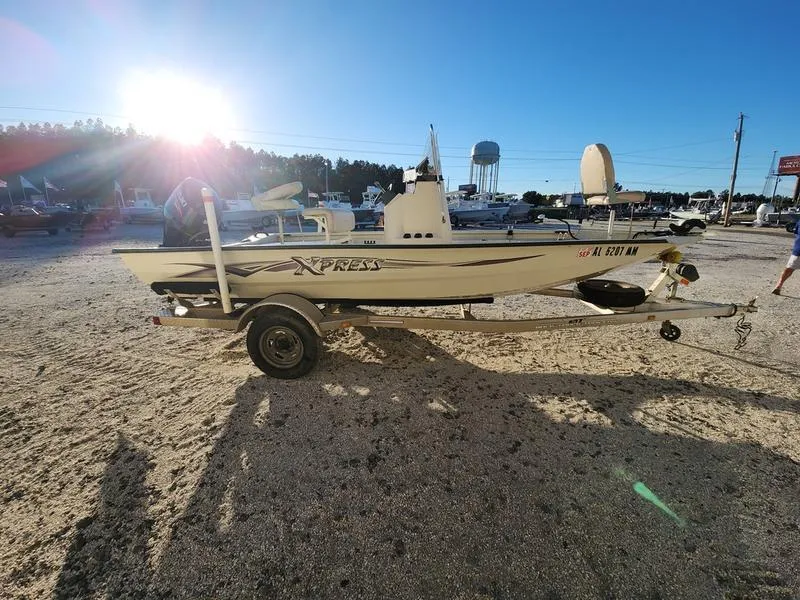 Slide: The Image of 2015 Xpress Hyper-Lift Bay Series H18B boat on trailer in sunny outdoor setting. - 8
