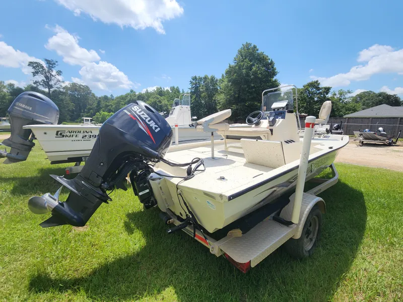 Slide: The Image of 2015 Xpress Hyper-Lift Bay Series H18B boat with Suzuki outboard motor on trailer. - 9