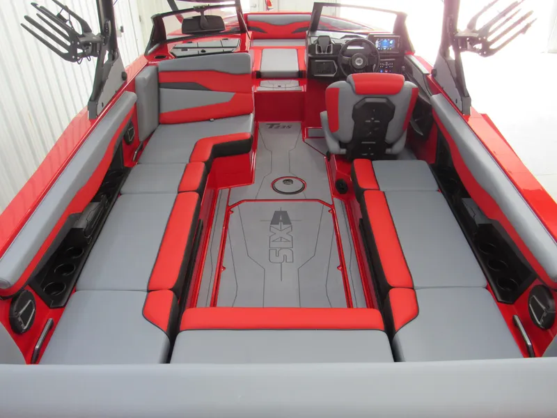 Slide: The Image of 2024 Axis T235 boat interior with red and gray seating, modern dashboard, and spacious layout. - 4