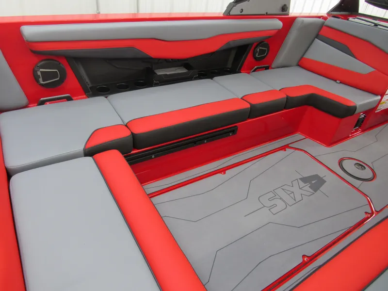 Slide: The Image of 2024 Axis T235 boat interior with red and gray seating and logo detailing. - 5