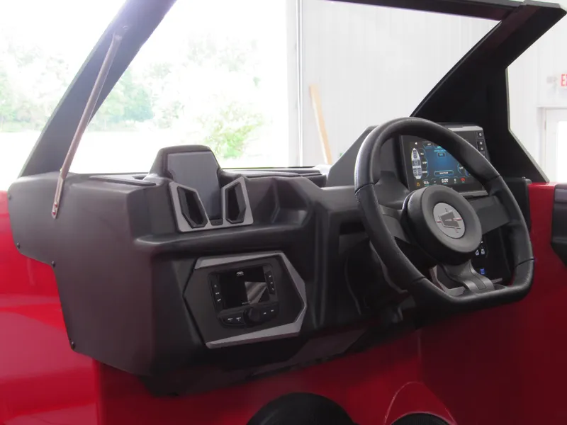 Slide: The Image of 2024 Axis T235 dashboard with steering wheel and digital display in a red interior. - 7
