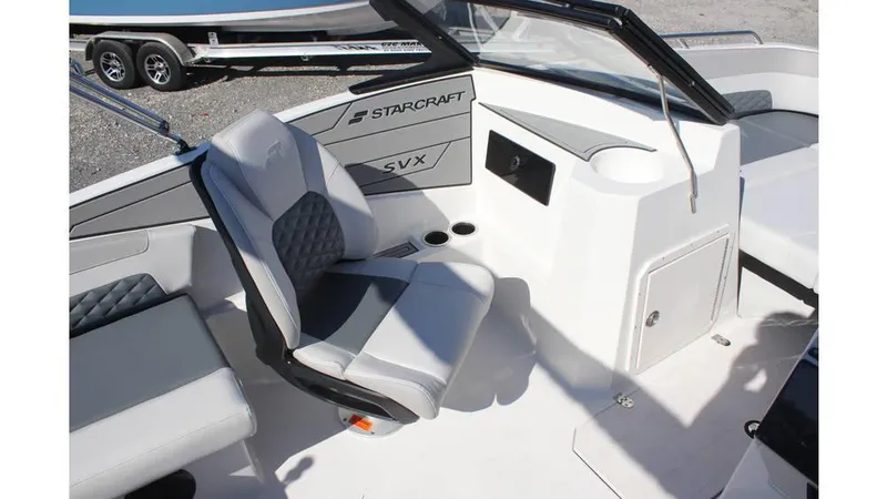 Slide: The Image of 2025 Starcraft SVX 190 OB DC boat interior with seating and console, showcasing modern design. - 10