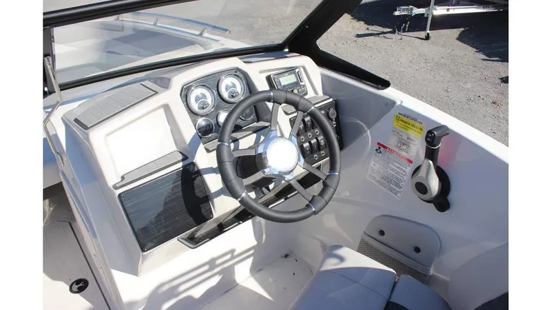 Slide: The Image of 2025 Starcraft SVX 190 OB DC boat dashboard with steering wheel and controls. - 13