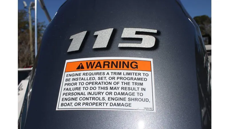 Slide: The Image of Warning label on a 2025 Starcraft SVX 190 OB DC engine, emphasizing trim limiter installation. - 15