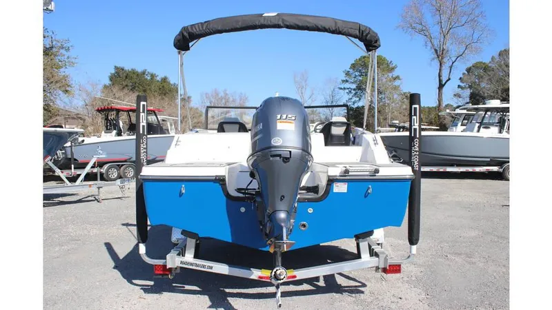 Slide: The Image of 2025 Starcraft SVX 190 OB DC boat, blue exterior, on trailer, rear view. - 3