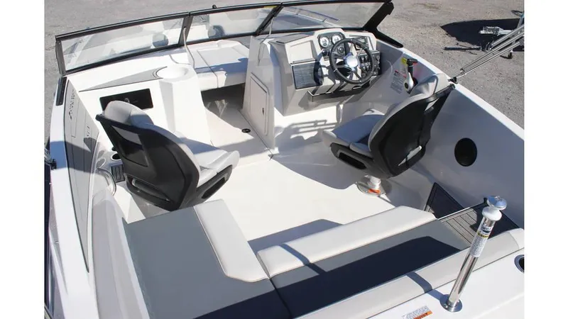 Slide: The Image of 2025 Starcraft SVX 190 OB DC boat interior with modern seating and steering console. - 6