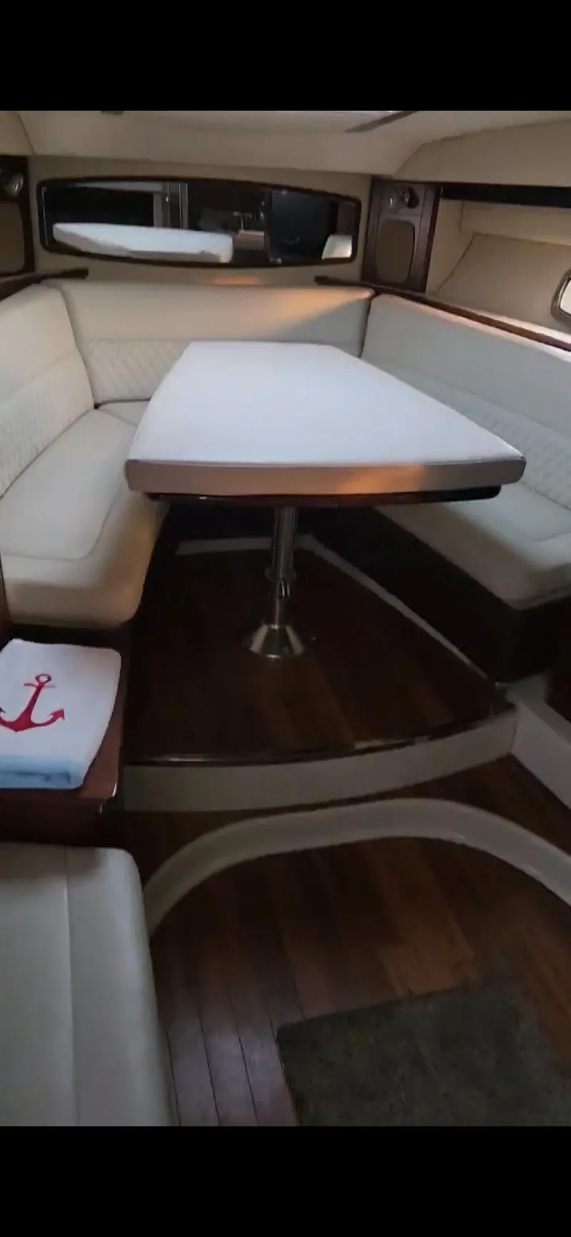 Slide: The Image of 2014 Chaparral 330 Signature Cruiser interior with elegant seating and dining area. - 13