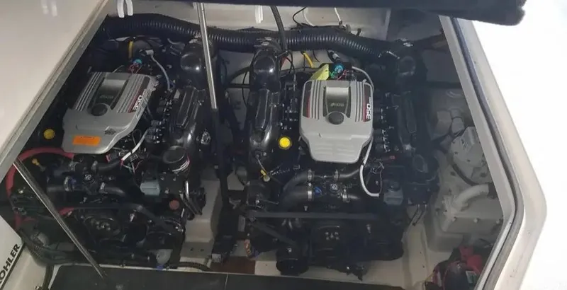 Slide: The Image of Engine compartment of a 2014 Chaparral 330 Signature Cruiser, featuring dual inboard motors. - 15