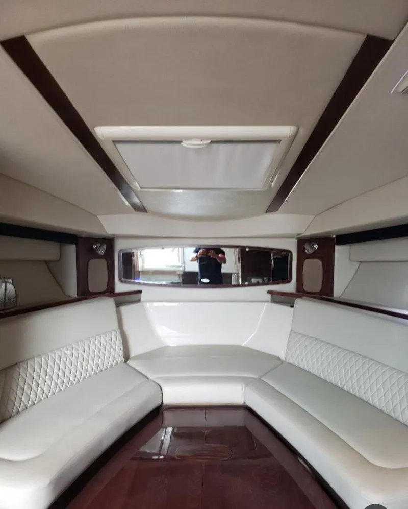 Slide: The Image of Interior of 2014 Chaparral 330 Signature Cruiser with elegant seating and wood accents. - 17