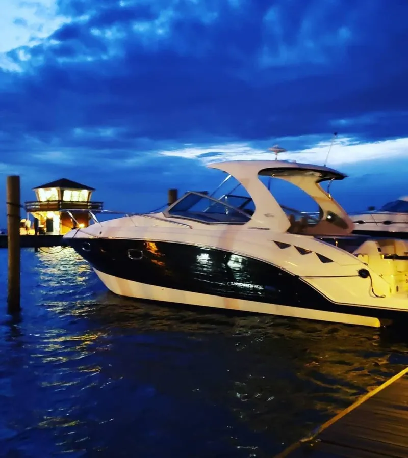 Slide: The Image of 2014 Chaparral 330 Signature Cruiser docked at sunset with vibrant blue sky. - 19