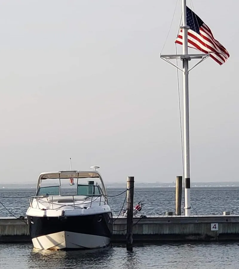 Slide: The Image of 2014 Chaparral 330 Signature Cruiser docked near American flag. - 3