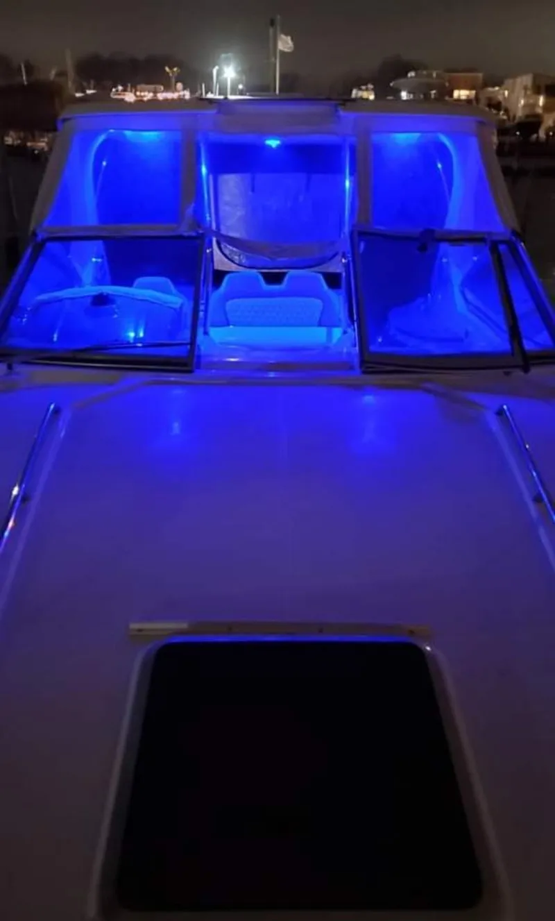 Slide: The Image of 2014 Chaparral 330 Signature Cruiser with blue interior lighting at night. - 4