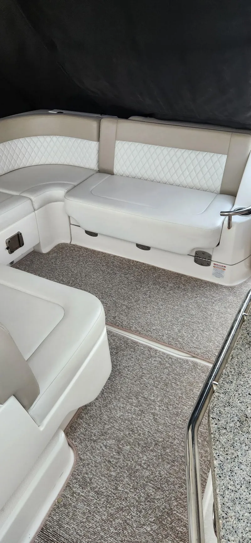 Slide: The Image of 2014 Chaparral 330 Signature Cruiser interior with beige seating and carpeted flooring. - 7