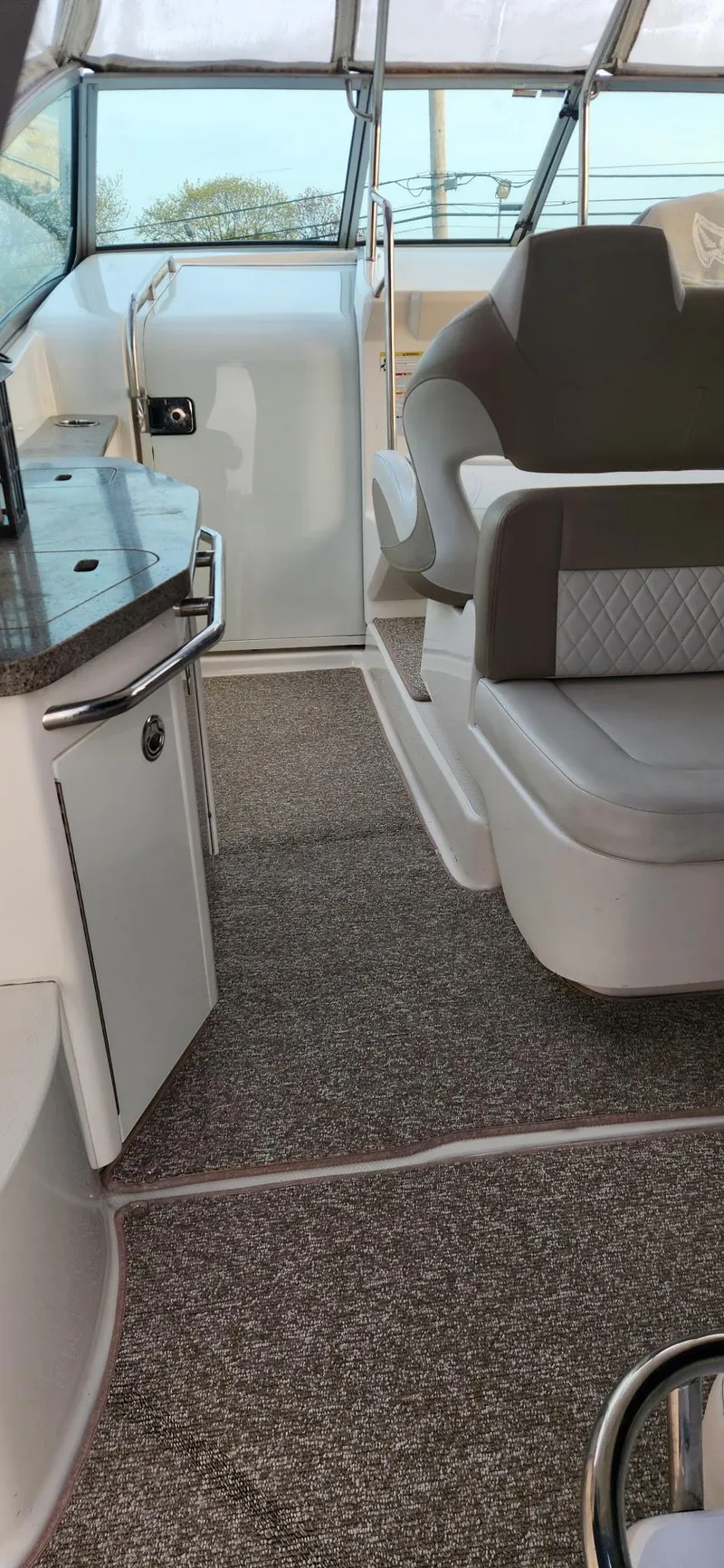 Slide: The Image of 2014 Chaparral 330 Signature Cruiser interior with seating and helm, featuring modern design elements. - 8