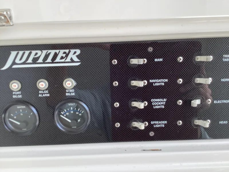 Slide: The Image of Control panel of a 2002 Jupiter 31 Cuddy boat with switches and gauges. - 10