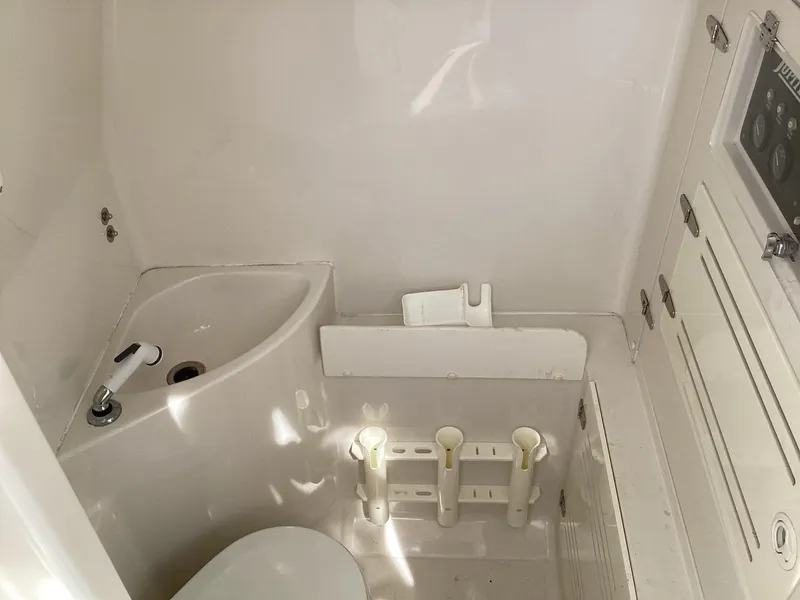 Slide: The Image of Compact bathroom in 2002 Jupiter 31 Cuddy boat with sink and storage. - 13