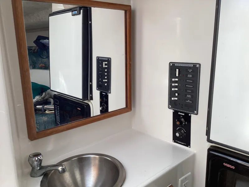 Slide: The Image of Interior of 2002 Jupiter 31 Cuddy with sink, mirror, and control panel. - 17