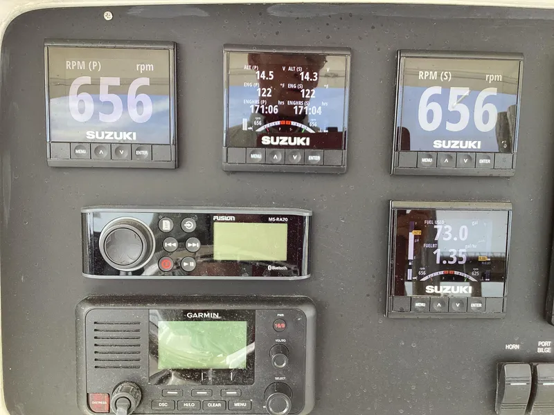 Slide: The Image of Control panel of a 2002 Jupiter 31 Cuddy boat with Suzuki and Garmin displays. - 18