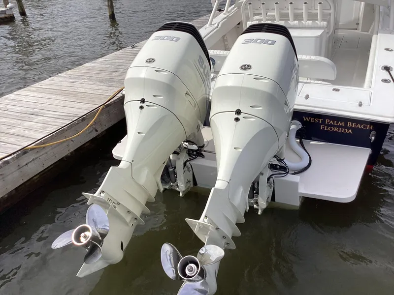 Slide: The Image of 2002 Jupiter 31 Cuddy boat with twin outboard engines docked in West Palm Beach, Florida. - 3