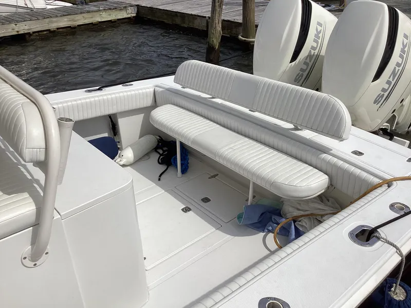 Slide: The Image of 2002 Jupiter 31 Cuddy boat interior with seating and Suzuki outboard motors. - 6