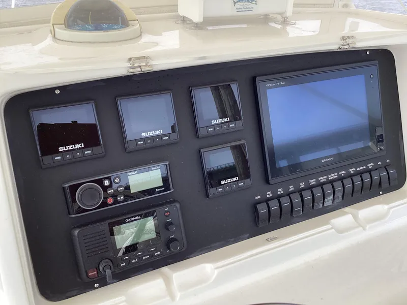 Slide: The Image of Control panel of a 2002 Jupiter 31 Cuddy boat with Suzuki and Garmin electronics. - 8