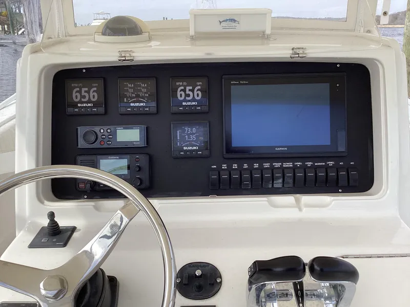 Slide: The Image of Control panel of a 2002 Jupiter 31 Cuddy boat with navigation instruments. - 9
