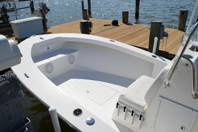 Slide: The Image of 2016 Layton Bay 22 boat docked, featuring spacious seating and sleek design. - 15