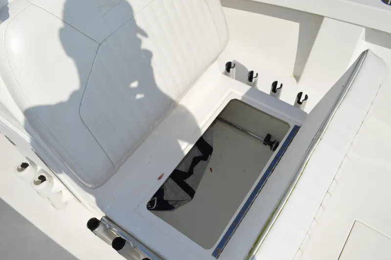 Slide: The Image of 2016 Layton Bay 22 boat with open storage compartment and white seating. - 16