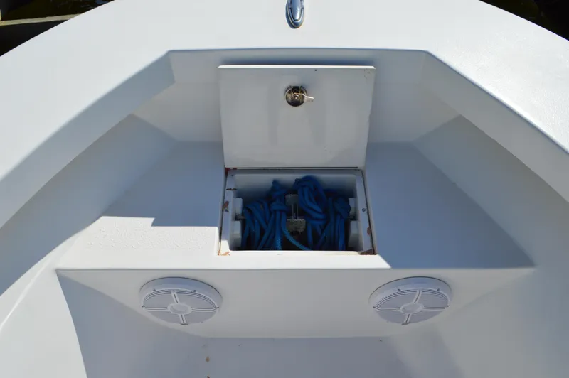 Slide: The Image of 2016 Layton Bay 22 boat storage compartment with blue rope and speakers. - 17