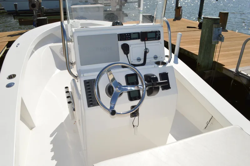 Slide: The Image of 2016 Layton Bay 22 boat console with steering wheel and navigation equipment. - 20