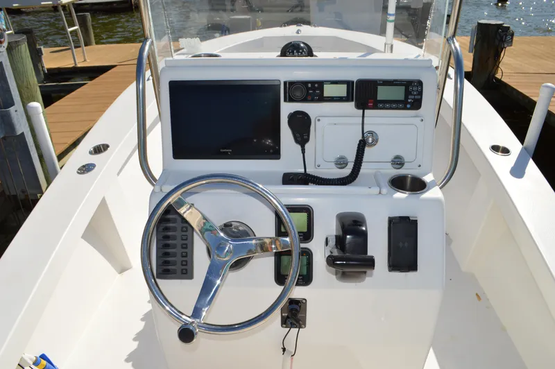 Slide: The Image of 2016 Layton Bay 22 boat console with steering wheel, navigation equipment, and controls. - 21