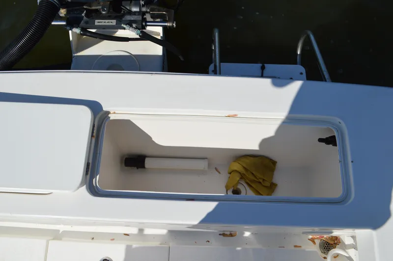 Slide: The Image of Open storage compartment on 2016 Layton Bay 22 boat with cleaning supplies. - 27