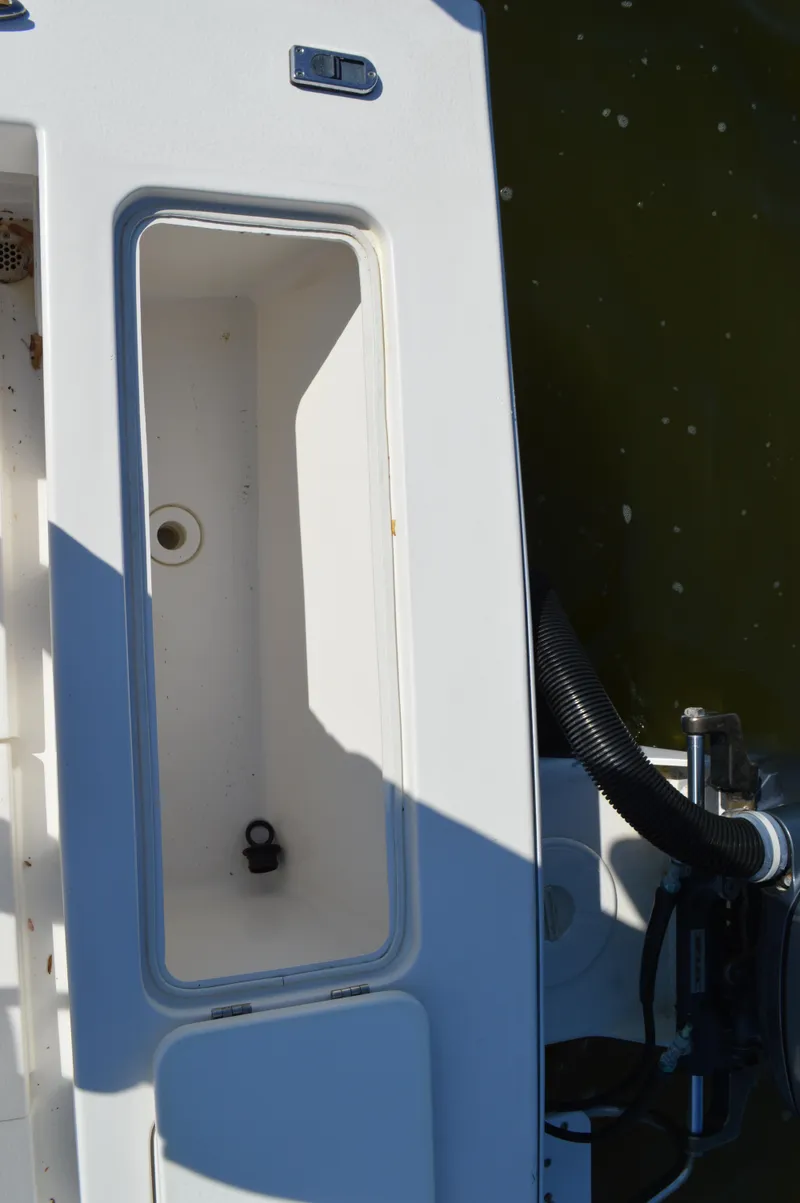 Slide: The Image of 2016 Layton Bay 22 boat deck with open storage compartment. - 28
