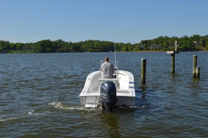 Slide: The Image of Man steering 2016 Layton Bay 22 boat on a calm lake. - 5