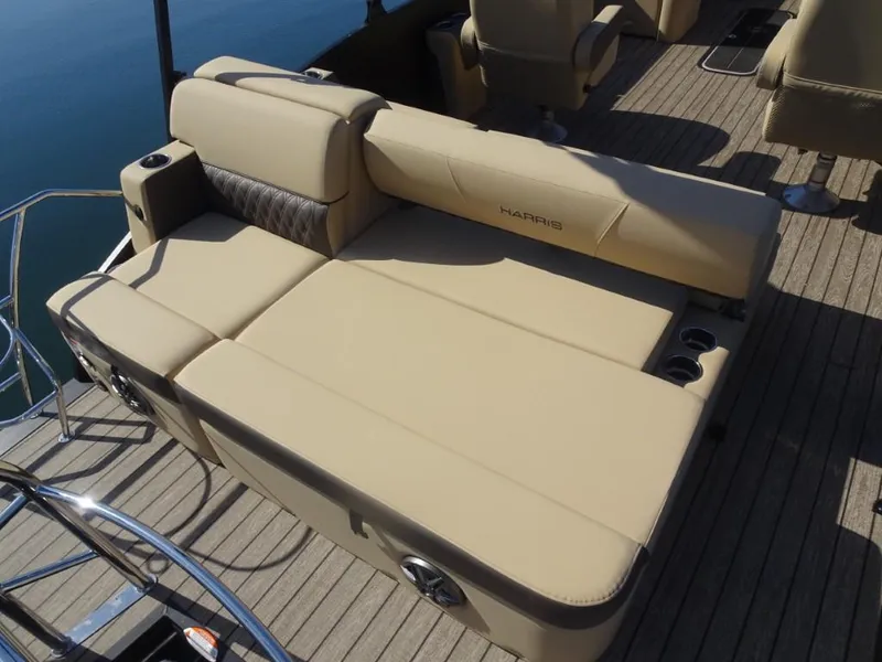 Slide: The Image of Luxurious seating on 2025 Harris Sunliner 250 pontoon boat, featuring beige upholstery and cup holders. - 10