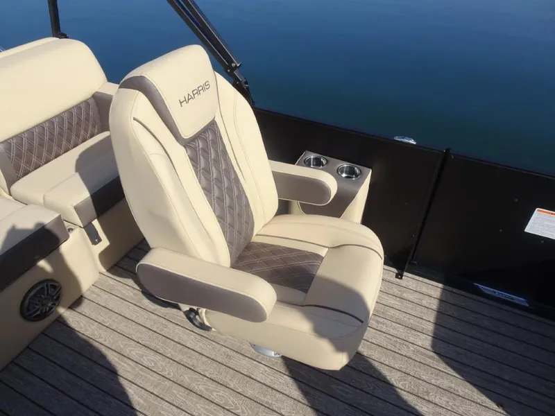 Slide: The Image of Luxurious seating on 2025 Harris Sunliner 250 boat with cup holders and elegant design. - 21