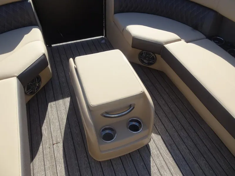 Slide: The Image of 2025 Harris Sunliner 250 interior with beige seating and central console on wooden deck. - 25