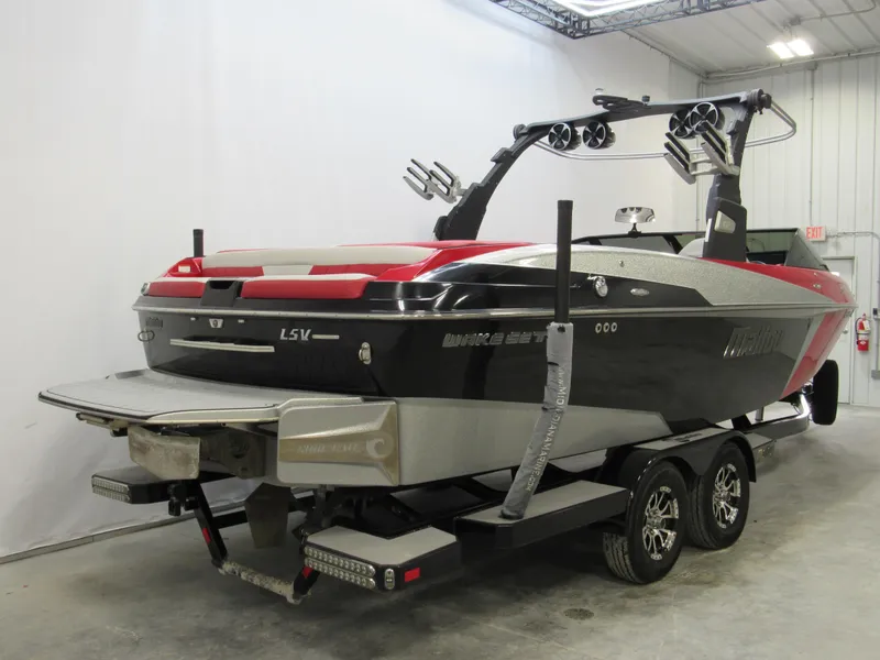 Slide: The Image of 2017 Malibu Wakesetter 25 LSV boat on trailer in indoor storage. - 2