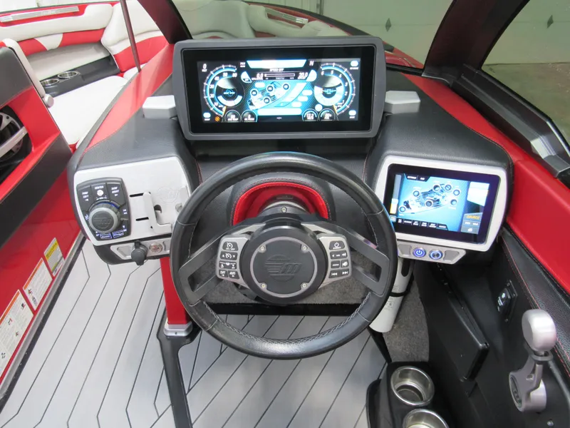 Slide: The Image of 2017 Malibu Wakesetter 25 LSV dashboard with advanced digital controls and steering wheel. - 6