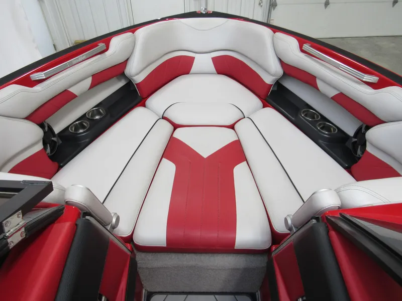 Slide: The Image of Red and white interior of 2017 Malibu Wakesetter 25 LSV boat with cup holders. - 7
