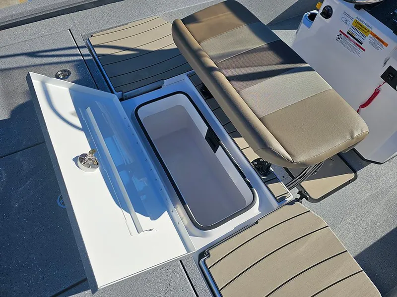 Slide: The Image of 2025 Vexus ACX2150 boat interior with open storage compartment and cushioned seating. - 11
