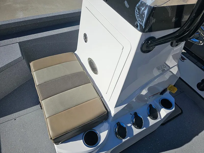 Slide: The Image of 2025 Vexus ACX2150 boat console with cushioned seat and cup holders. - 16