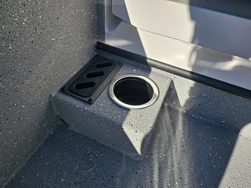 Slide: The Image of Interior of 2025 Vexus ACX2150 boat featuring a cup holder and textured flooring. - 23
