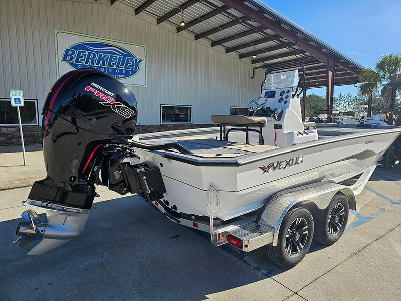 Slide: The Image of 2025 Vexus ACX2150 boat on trailer outside Berkeley building. - 3