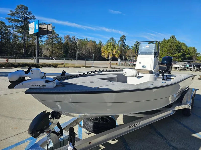 Slide: The Image of 2025 Vexus ACX2150 boat on trailer, featuring Minn Kota trolling motor, parked outdoors. - 5