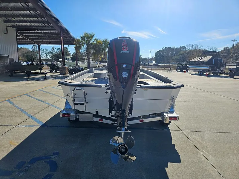 Slide: The Image of 2025 Vexus ACX2150 boat on trailer, rear view, parked outdoors under clear sky. - 8